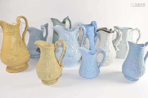 Group of ten relief moulded 19th century pottery jugs by various manufacturers including a jug of