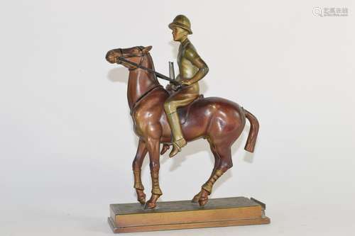 Vintage spelter figure of a mounted female polo player, 19cm high