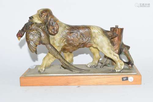 Cold cast painted table lighter depicting a spaniel carrying a pheasant in its mouth, on wooden