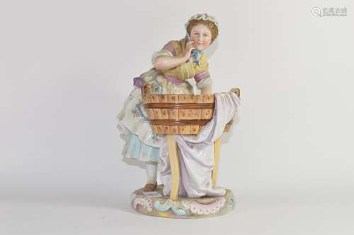 Late 19th century Continental porcelain model of a washer girl on a circular base with tub of