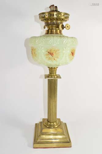 Oil lamp with glass reservoir above a Corinthian column brass base