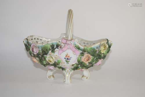 Continental porcelain flower basket on four scroll feet, the sides decorated with flower heads in