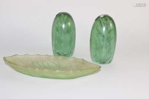 Pair of Nailsea type green paperweights together with a further green glass dish (3)