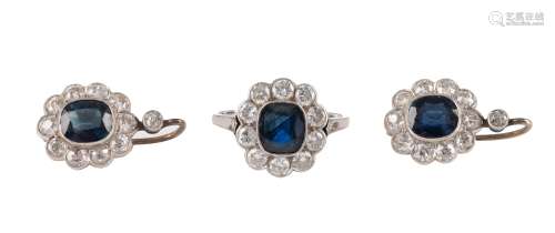 A three-part jewellery set consisting of an 18ct white gold ring, central set with a cushion-cut sapphire and all-around mounted with 10 brilliant-cut diamonds, the total weight 4,2 g, and added a pair of 14ct white g...