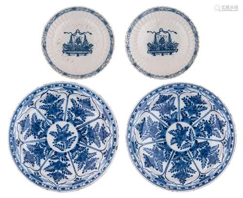 A pair of blue and white floral decorated Dutch Delftware plates, 18thC, ø 34 cm. Added: a pair of ditto Dutch Delftware dishes, with a fluted rim and decorated with a flower basket, 18thC, ø 23,5 cm