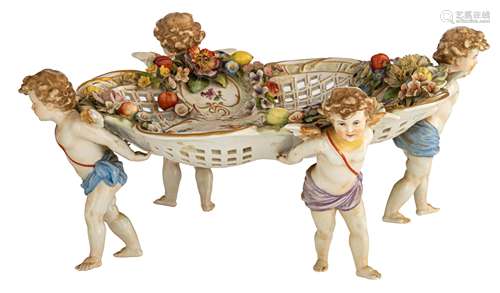 A polychrome decorated Saxony porcelain 'pièce de milieu' with four angels carrying the openworked basket, relief decorated with flowers and fruit, marked Plaue, H 15,5 - ø 39 cm