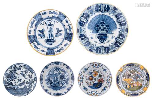 A late 18thC blue and white Delftware so-called 'Pauwstaart' (peacock tail), marked 'De Clauw'. Added five other Delft plates, polychrome and blue decorated with flowers and birds, early 19thC, the plate with the bird...