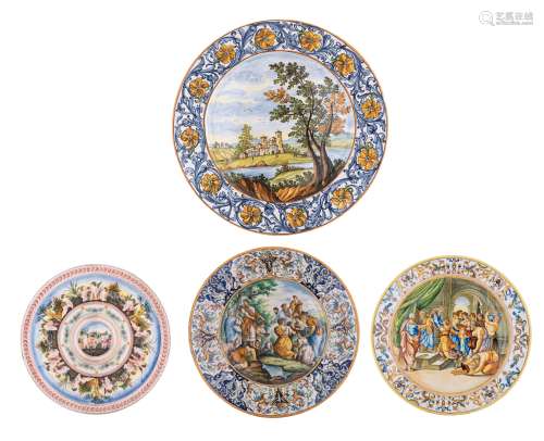 A collection of three large plates in the manner of the Italian Renaissance Maiolica, the wells decorated with scrollwork and the central scenes depicting Moses and the water miracle at Rephidim (signed Battaglin, ø 5...