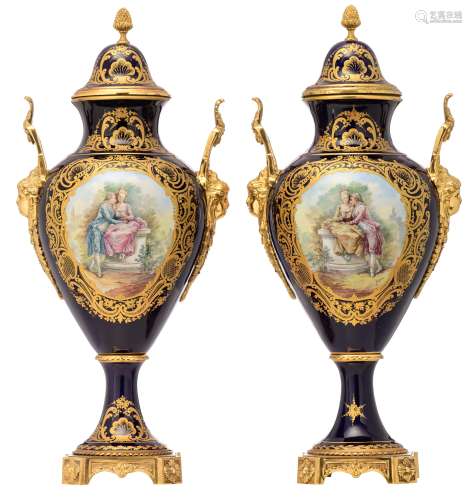 A pair of covered bleu royale ground Sèvres vases with gilt bronze mounts, the roundels polychrome decorated with gallant scenes, signed by J. Césana, H 62 - 62,5 cm