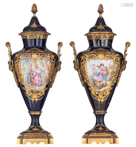 A pair of covered bleu royale ground Sèvres type vases with Neoclassical gilt bronze mounts, the roundels polychrome decorated with hand-painted gallant scenes of a romance between a young couple, signed Dupuit, H 45,...
