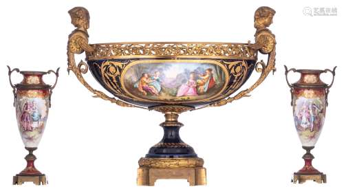 A large bleu royale ground Sèvres coupe with fine gilt bronze mounts and sphinx-shaped handles, the front roundel decorated with a hand-painted gallant scene, H 44,5 - W 52 cm. Added: a matching pair of red ground Sèv...