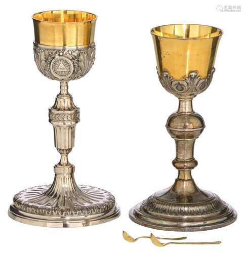 Two 19thC neoclassical relief decorated silver and gilt silver chalices: one weighing c. 612 g - H 28 cm, and with a matching spoon - one with owner's engraving 'Eerw. Paters Capucynen - Boeveriestraat - Brugge - 1884...