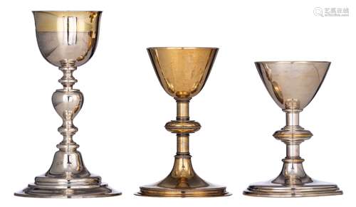 Two silver and gilt silver 19thC chalices, one with the inscription 'Capucijnessen - Brugge', weight c. 648 g - H 25,8 cm - the other one decorated with bead borders to the foot, to the connection of the foot to the s...