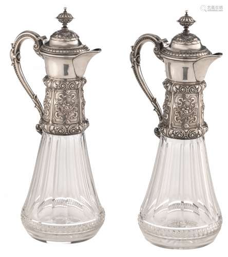 A fine pair of crystal cut decanters with Neoclassical silver and gilt silver mounts, decorated with scrollwork, garlands and fruit baskets, no visible hallmarks but tested on silver purity, late 19thC, H 35 cm