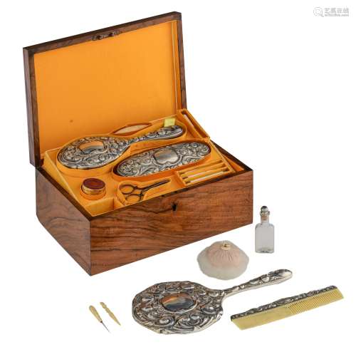 A luxurious walnut ladies vanity box, with Rococo-inspired silver, bone and glass utensils, and a guilloché enamelled powder box with inscription 'La Poudre Compacte d'Orsay', the inside of the box upholstered with si...