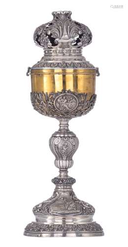 A Neoclassical silver and gilt silver ciborium with an openworked cover, the roundels decorated with scenes depicting the way of sorrows, saints and the Evangelists, Brussels hallmark and maker's mark Nicolas Laurent ...