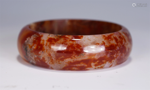 A CHINESE CARVED AGATE BANGLE
