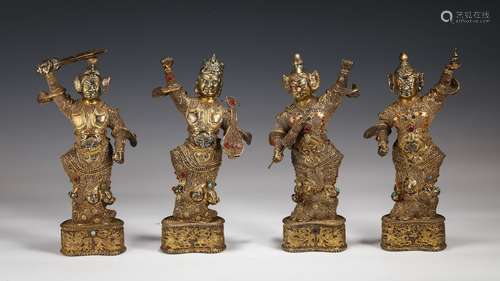 A Set Of Four Gilt Bronze Immortals With Inlaid Stone