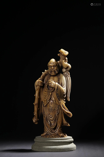 A CARVED SOAPSTONE FIGURE OF DAMO.QING PERIOD 清