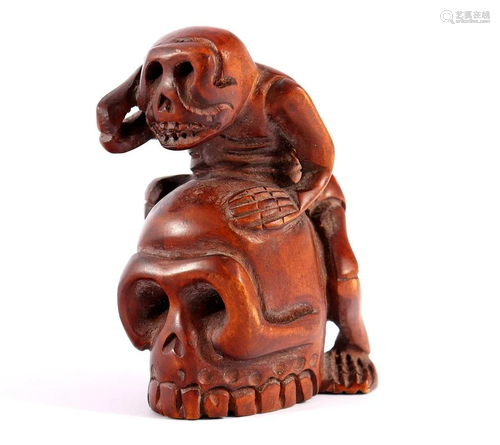 Boxwood netsuke of skeleton on skull