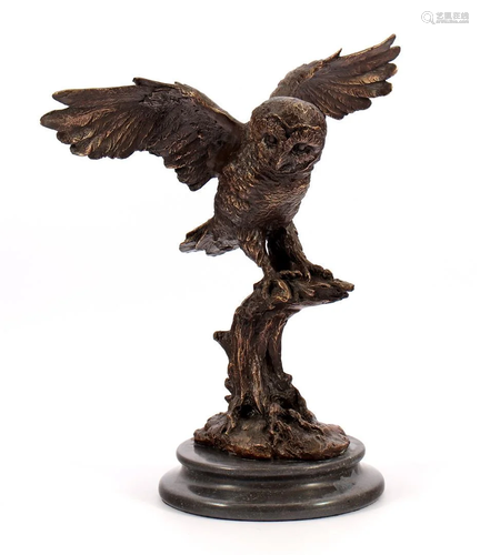 Bronze statue of an owl on a branch