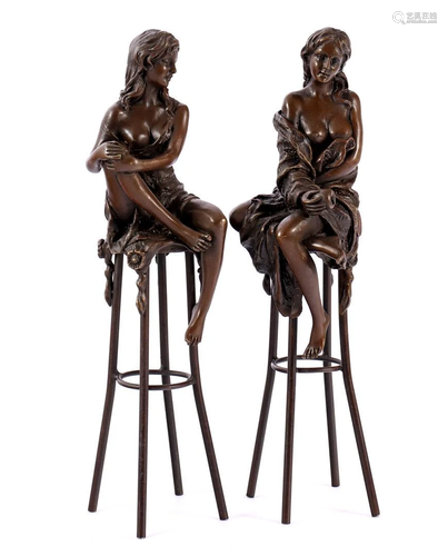 2 bronze sculptures of seated ladies on a stool