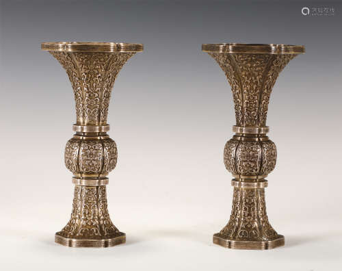 A PAIR OF CHINESE SILVER VASES WITH CARVED PATTERNS