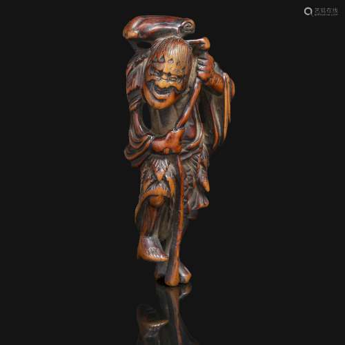 NETSUKE伽玛仙人的木雕，单脚站立，拄着棍子，肩上扛着蛤蟆。署名行庆。日本，江户时代，18世纪末19世纪初。木制网状物，站立的伽马仙人，签名为GYOKKEI，日本，18世纪末至19世纪初。高度：9厘米(3 9/16英寸)