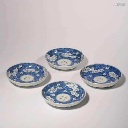 A SET OF FOUR BLUE AND WHITE FLORAL PORCELAIN SAUCERS