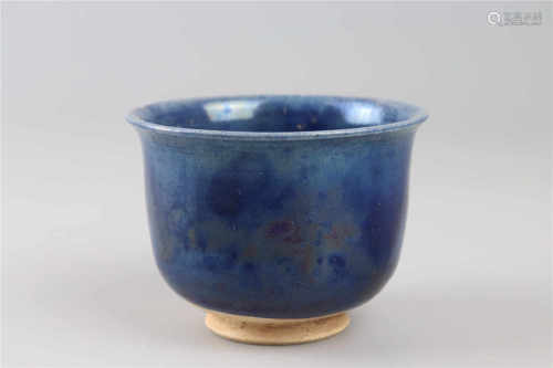 A blue glazed cup