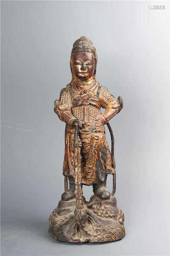 A gilded bronze guardian figure