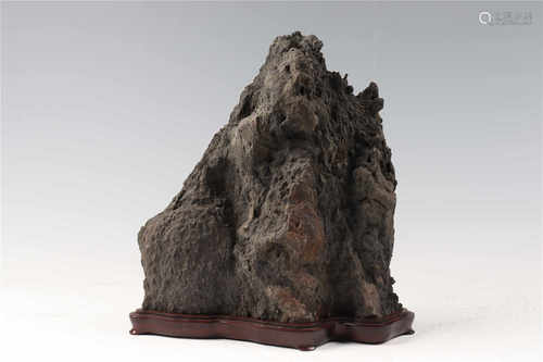 A decorative mountain with wooden stand