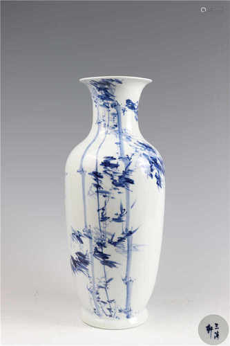 A blue and white flower vase with calligraphy inscriptions