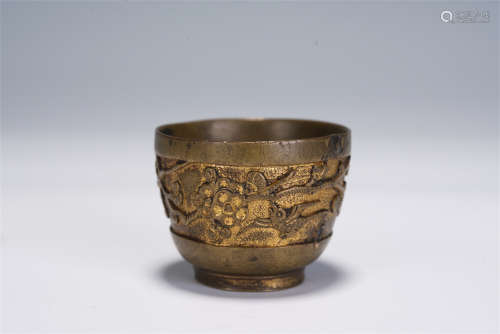 A CHINESE CARVED GILT BRONZE CUP