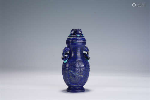 A CHINESE CARVED LAPIS LAZULI VASE WITH COVER