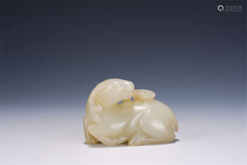A CHINESE CARVED WHITE JADE SHEEP-SHAPED PAPERWEIGHT