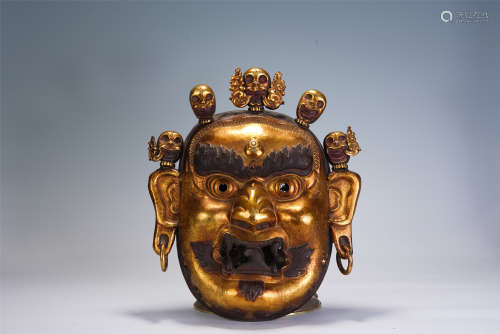 A CHINESE CARVED GILT BRONZE BUDDHA FACE
