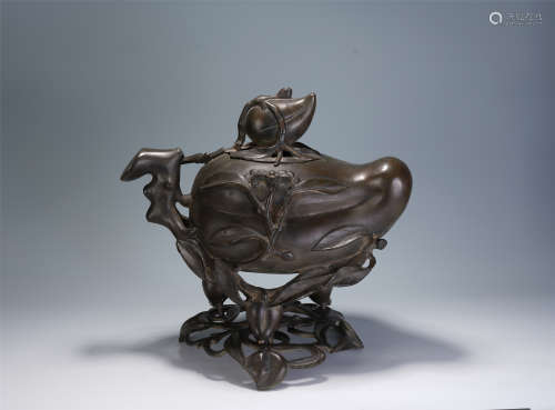 A CHINESE CARVED PEACH-SHAPED BRONZE INCENSE BURNER