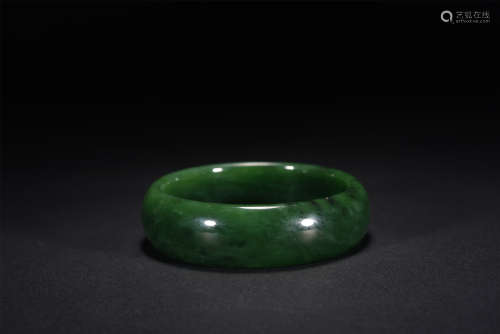 A CHINESE CARVED JASPER BANGLE