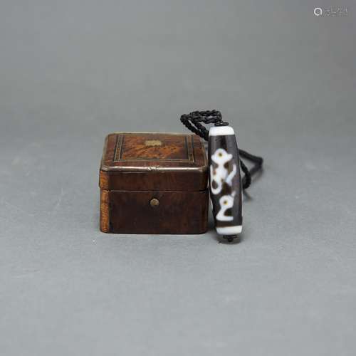 A TIBETAN DZI BEAD WITH BOX