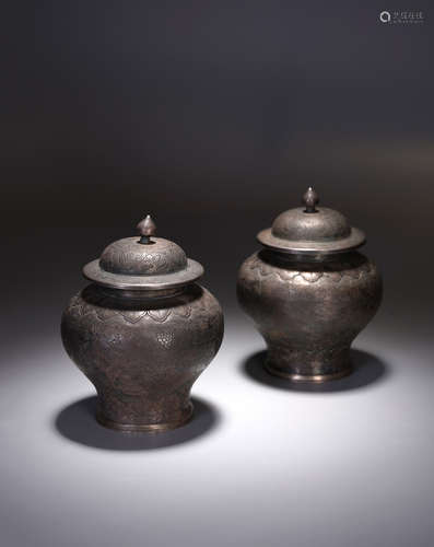 A PAIR OF CHINESE SILVER 'FLOWERS' ENGRAVED JARS AND COVERS