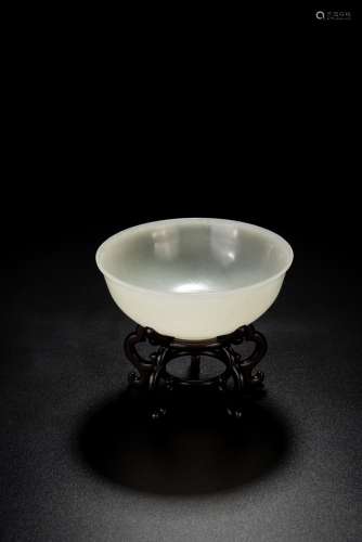 A WHITE JADE CARVED BOWL WITH HARDWOOD STAND