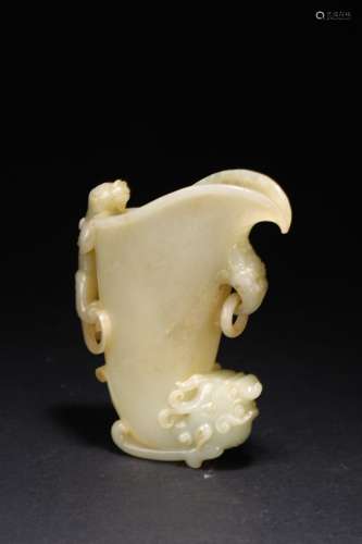 A CHINESE RUSSET AND WHITE JADE RHYTON