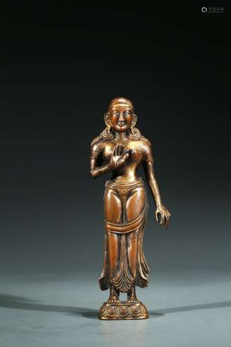 A COPPER ALLOY FIGURE OF STANDING FIGURE