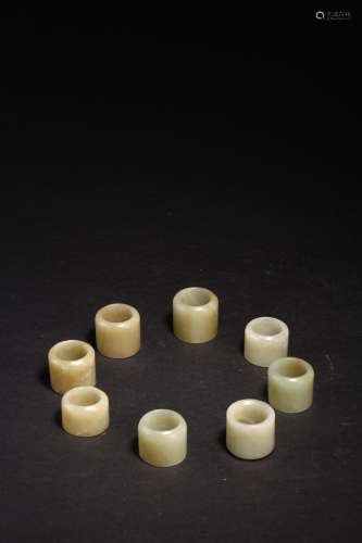 A SET OF EIGHT WHITE JADE ARCHER'S RINGS