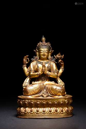 A GILT BRONZE FIGURE OF FOUR-ARMED BODHISATTVA