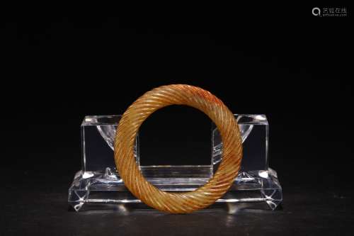 A CHINESE YELLOW JADE 'ROPE-TWIST' BANGLE