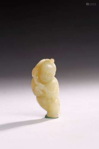 A WHITE JADE CARVING OF BOY HOLDING LOTUS