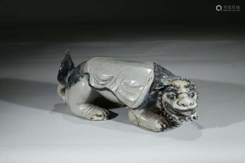 A PORCELAIN FIGURE OF BUDDHIST LION