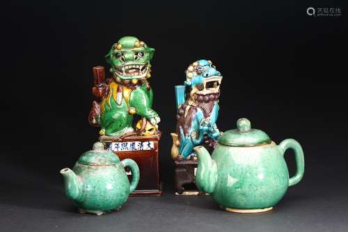 A GROUP OF FOUR GLAZED BUDDHIST LIONS AND TEAPOTS